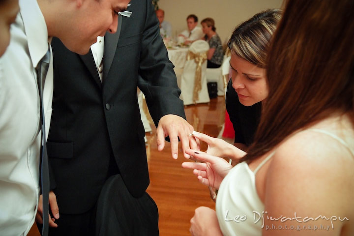 Guests looking and admiring bride and groom's wedding rings. Fredericksburg Square Wedding, Fredericksburg Virginia Wedding Photographer