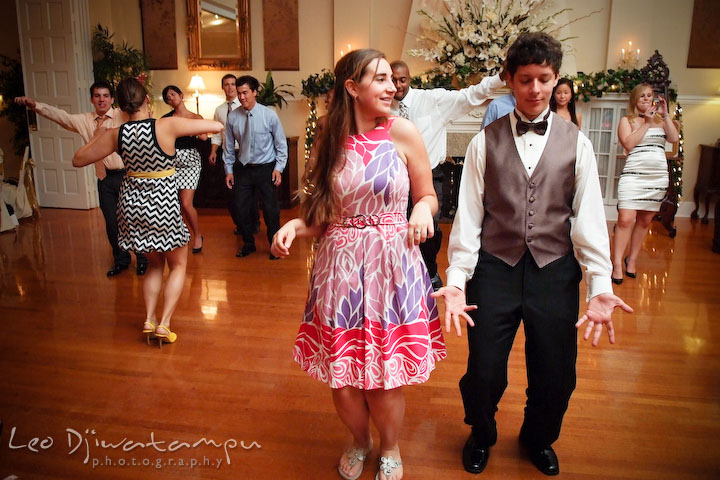 Groomsman and his girlfriend dancing to Cha Cha Slide song. Fredericksburg Square Wedding, Fredericksburg Virginia Wedding Photographer