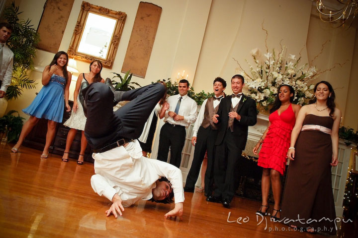One guy doing breakdance on the floor spinning his body upside down. Fredericksburg Square Wedding, Fredericksburg Virginia Wedding Photographer