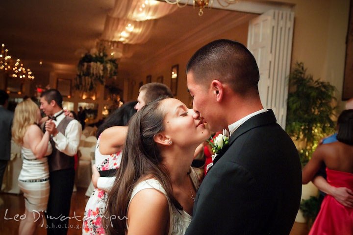 Bride and groom stealing a kiss while slow dancing with other guests. Fredericksburg Square Wedding, Fredericksburg Virginia Wedding Photographer