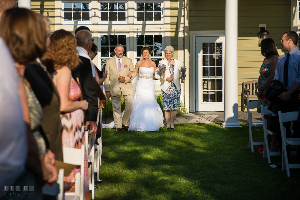 Chesapeake Bay Beach Club Bride walking down the aisle escorted by Father and Mother photo by Leo Dj Photography