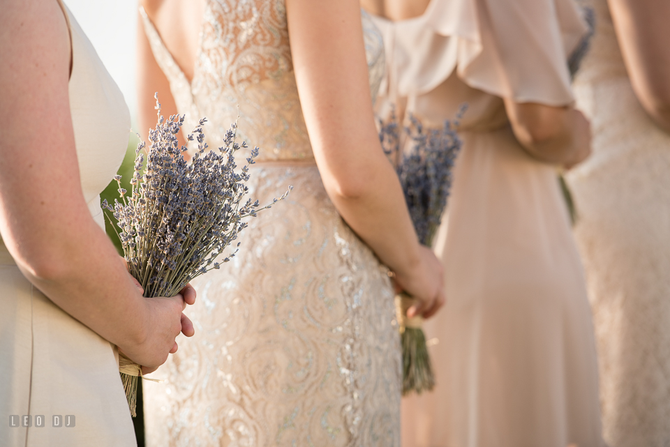 Chesapeake Bay Beach Club Groom bridesmaids holding lavender floral bouquets during ceremony photo by Leo Dj Photography