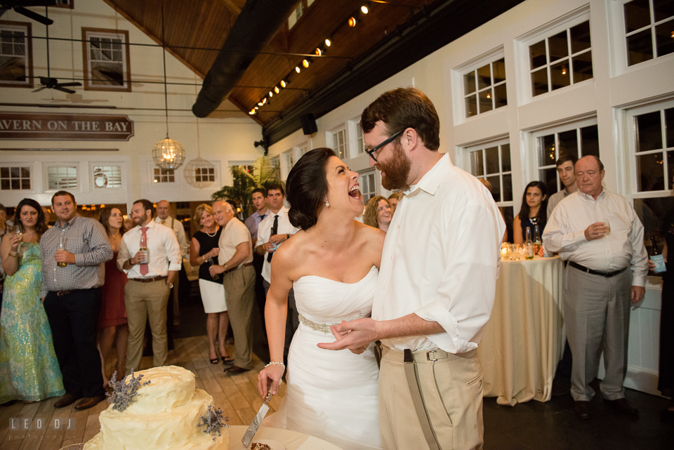 Chesapeake Bay Beach Club Bride and Groom laughin while cutting cake photo by Leo Dj Photography