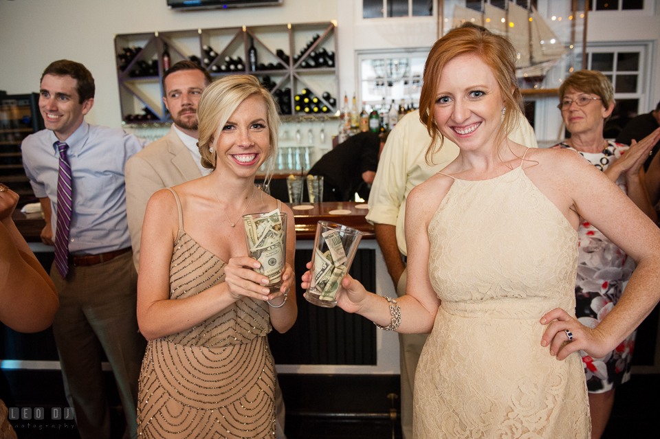 Chesapeake Bay Beach Club Bridesmaids showing the catch of the day from money dance photo by Leo Dj Photography