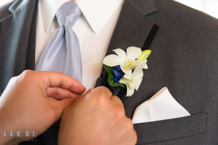 White orchids boutonniere for Groom, Best Man, and Groomsmen. Kent Island Maryland Chesapeake Bay Beach Club wedding ceremony and getting ready photo, by wedding photographers of Leo Dj Photography. http://leodjphoto.com