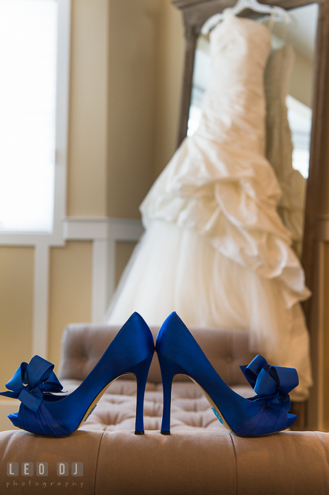 Bride's blue wedding shoes with wedding gown in the background. Kent Island Maryland Chesapeake Bay Beach Club wedding ceremony and getting ready photo, by wedding photographers of Leo Dj Photography. http://leodjphoto.com