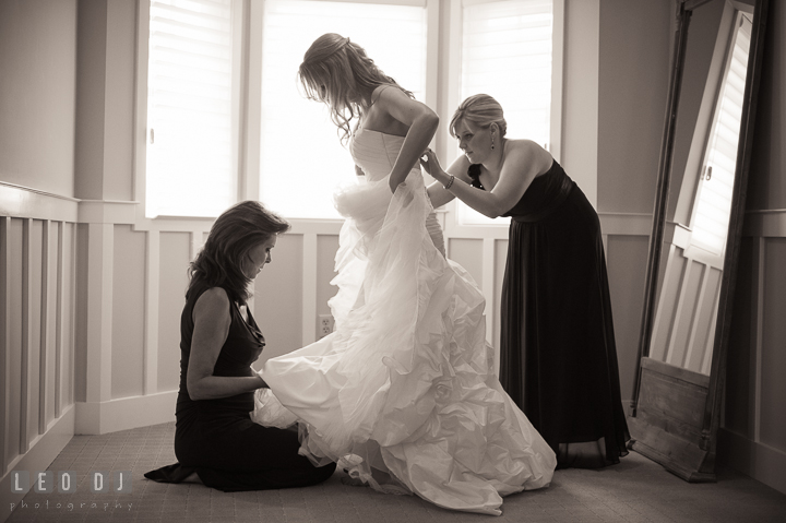 Maid of Honor and Mother of Bride helping putting on wedding gown on Bride. Kent Island Maryland Chesapeake Bay Beach Club wedding ceremony and getting ready photo, by wedding photographers of Leo Dj Photography. http://leodjphoto.com