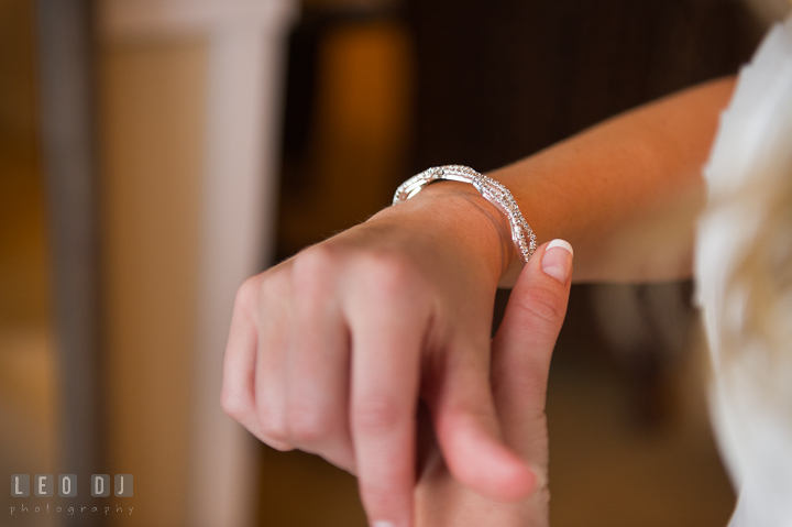 Bride putting on diamond bracelet on her wrist. Kent Island Maryland Chesapeake Bay Beach Club wedding ceremony and getting ready photo, by wedding photographers of Leo Dj Photography. http://leodjphoto.com