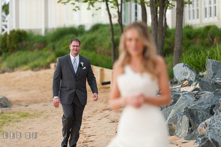 Groom walking down to meet his Bride during first glance. Kent Island Maryland Chesapeake Bay Beach Club wedding ceremony and getting ready photo, by wedding photographers of Leo Dj Photography. http://leodjphoto.com