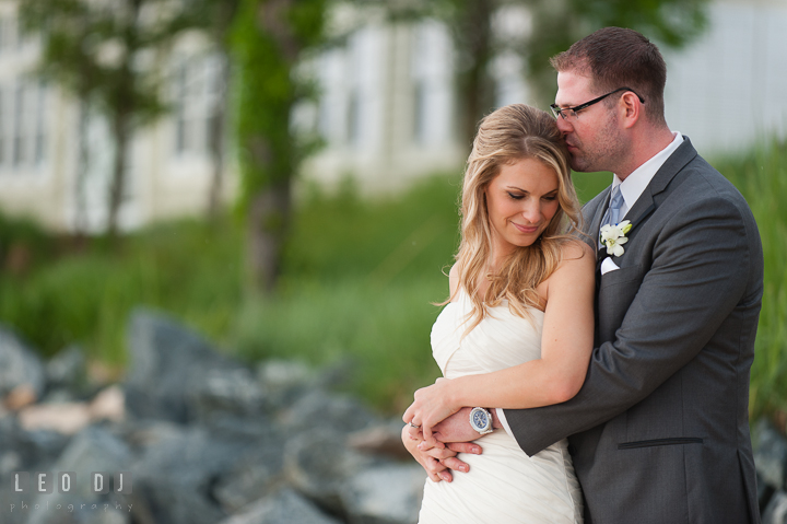 Groom hugging Bride on the beach. Kent Island Maryland Chesapeake Bay Beach Club wedding ceremony and getting ready photo, by wedding photographers of Leo Dj Photography. http://leodjphoto.com