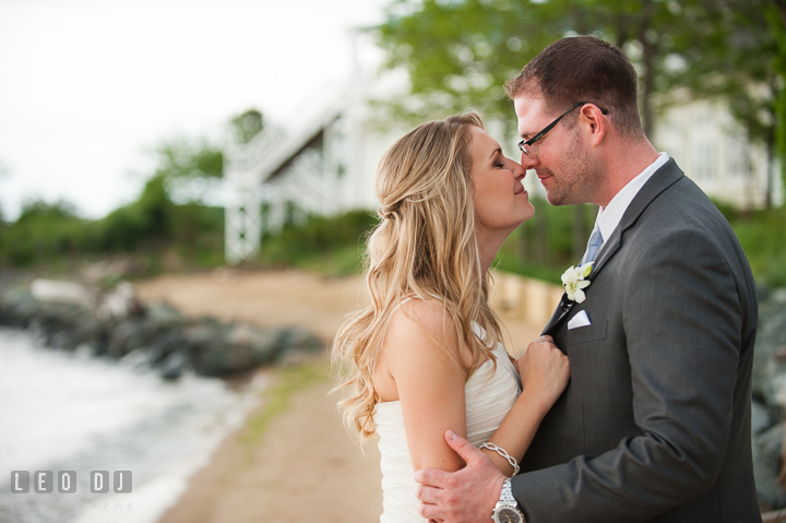 Bride and Groom on the beach cuddling. Kent Island Maryland Chesapeake Bay Beach Club wedding ceremony and getting ready photo, by wedding photographers of Leo Dj Photography. http://leodjphoto.com