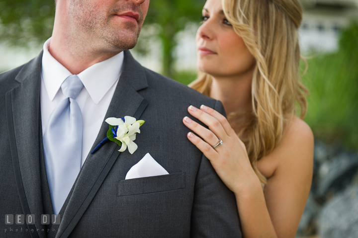 Bride and Groom looking at each other while showing boutonniere. Kent Island Maryland Chesapeake Bay Beach Club wedding ceremony and getting ready photo, by wedding photographers of Leo Dj Photography. http://leodjphoto.com