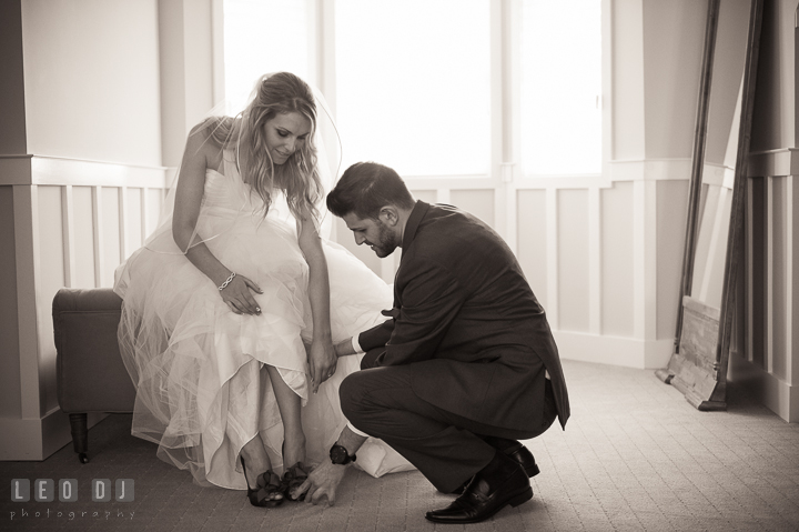 Man of Honor helping Bride put on her wedding shoes. Kent Island Maryland Chesapeake Bay Beach Club wedding ceremony and getting ready photo, by wedding photographers of Leo Dj Photography. http://leodjphoto.com