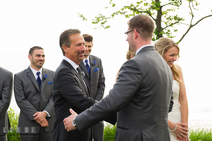 Bride laughed after Father did a joke on Groom. Kent Island Maryland Chesapeake Bay Beach Club wedding ceremony and getting ready photo, by wedding photographers of Leo Dj Photography. http://leodjphoto.com