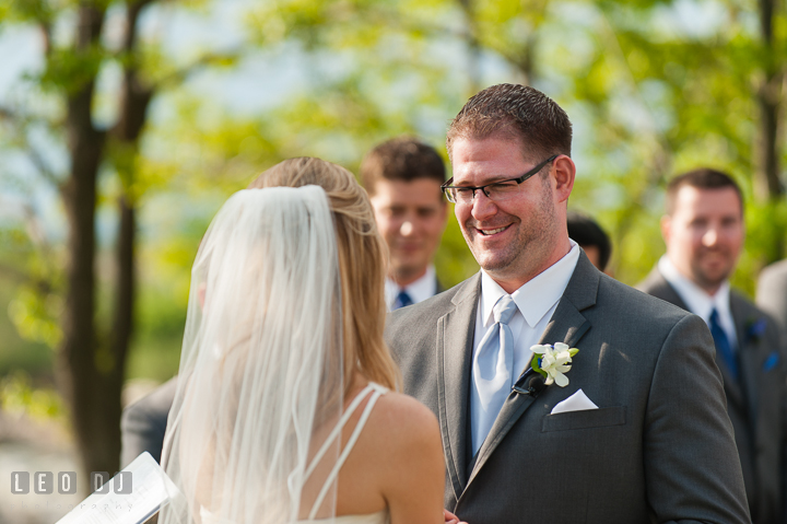 Groom reciting vow to Bride. Kent Island Maryland Chesapeake Bay Beach Club wedding ceremony and getting ready photo, by wedding photographers of Leo Dj Photography. http://leodjphoto.com