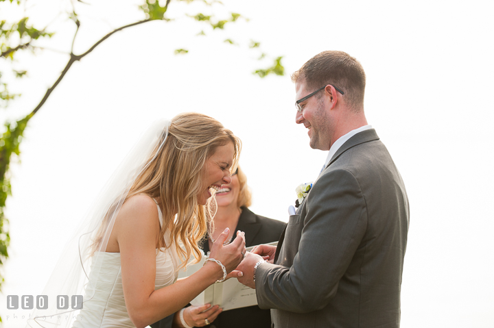 Bride laughing as Groom goofed up his words. Kent Island Maryland Chesapeake Bay Beach Club wedding ceremony and getting ready photo, by wedding photographers of Leo Dj Photography. http://leodjphoto.com