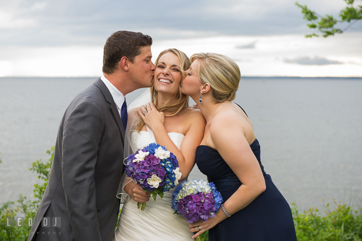 Bride kissed by Brother and Maid of Honor. Kent Island Maryland Chesapeake Bay Beach Club wedding reception party photo, by wedding photographers of Leo Dj Photography. http://leodjphoto.com