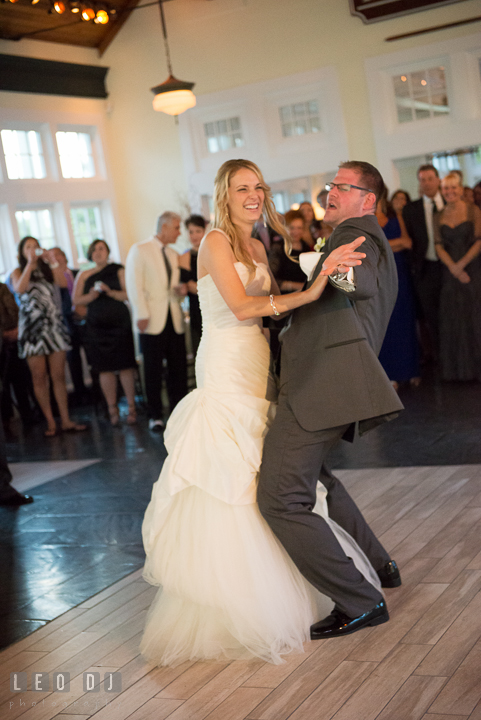 Groom doing silly dance while doing first dance with Bride. Kent Island Maryland Chesapeake Bay Beach Club wedding reception party photo, by wedding photographers of Leo Dj Photography. http://leodjphoto.com