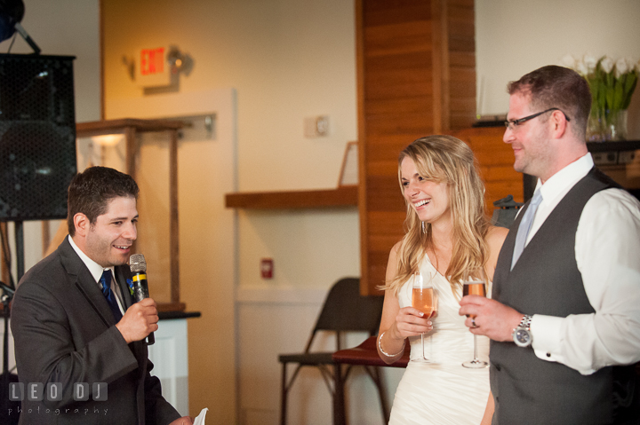 Bride and Groom laughing listening to Best Man's speech. Kent Island Maryland Chesapeake Bay Beach Club wedding reception party photo, by wedding photographers of Leo Dj Photography. http://leodjphoto.com