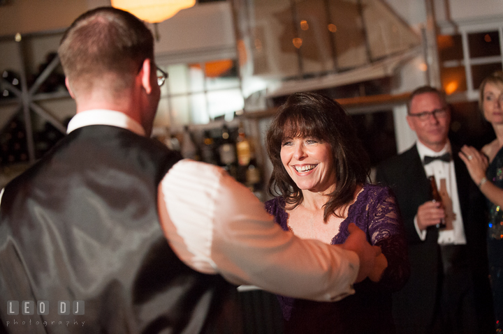 Mother of Groom laughing while dancing with son. Kent Island Maryland Chesapeake Bay Beach Club wedding reception party photo, by wedding photographers of Leo Dj Photography. http://leodjphoto.com