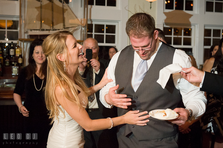 Bride laughing hard after her prank on Groom. Kent Island Maryland Chesapeake Bay Beach Club wedding reception party photo, by wedding photographers of Leo Dj Photography. http://leodjphoto.com