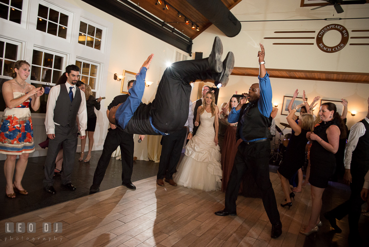 One of the male singer from Onyx Band jumped in the air. Kent Island Maryland Chesapeake Bay Beach Club wedding reception party photo, by wedding photographers of Leo Dj Photography. http://leodjphoto.com