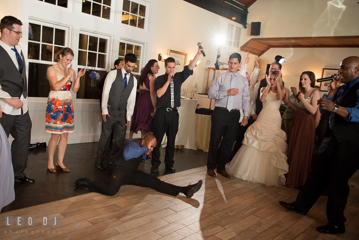 Singer landed with split on ground after somersault jump. Kent Island Maryland Chesapeake Bay Beach Club wedding reception party photo, by wedding photographers of Leo Dj Photography. http://leodjphoto.com