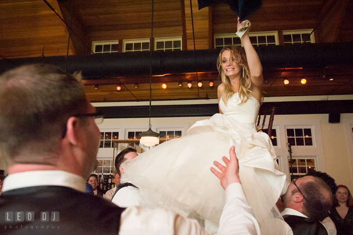 Bride still up in the air on her chair and Groom asked her to come down. Kent Island Maryland Chesapeake Bay Beach Club wedding reception party photo, by wedding photographers of Leo Dj Photography. http://leodjphoto.com