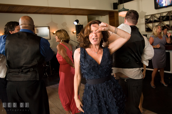 One lady guest doing the pulp fiction dance. Kent Island Maryland Chesapeake Bay Beach Club wedding reception party photo, by wedding photographers of Leo Dj Photography. http://leodjphoto.com