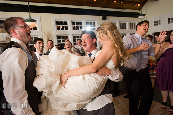 Bride's Brother lifted up and carried his sister. Kent Island Maryland Chesapeake Bay Beach Club wedding reception party photo, by wedding photographers of Leo Dj Photography. http://leodjphoto.com