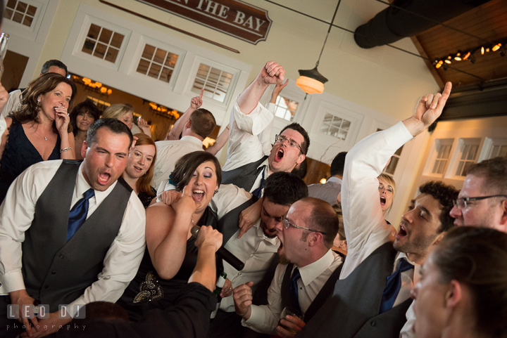 Guests passionately singing along with the band. Kent Island Maryland Chesapeake Bay Beach Club wedding reception party photo, by wedding photographers of Leo Dj Photography. http://leodjphoto.com