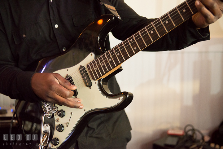 Close up shot of Onyx Band guitarist playing his guitar. Kent Island Maryland Chesapeake Bay Beach Club wedding reception party photo, by wedding photographers of Leo Dj Photography. http://leodjphoto.com