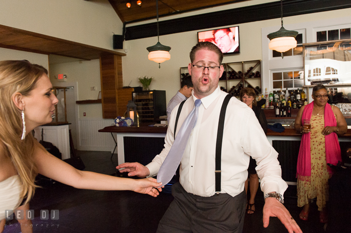 Bride pulling Groom's tie while dancing. Kent Island Maryland Chesapeake Bay Beach Club wedding reception party photo, by wedding photographers of Leo Dj Photography. http://leodjphoto.com