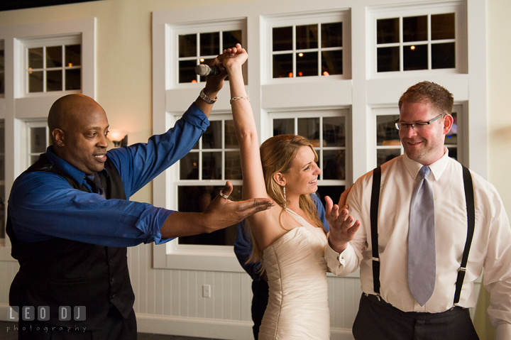 Onyx Band singer lift up Bride's hand. Kent Island Maryland Chesapeake Bay Beach Club wedding reception party photo, by wedding photographers of Leo Dj Photography. http://leodjphoto.com