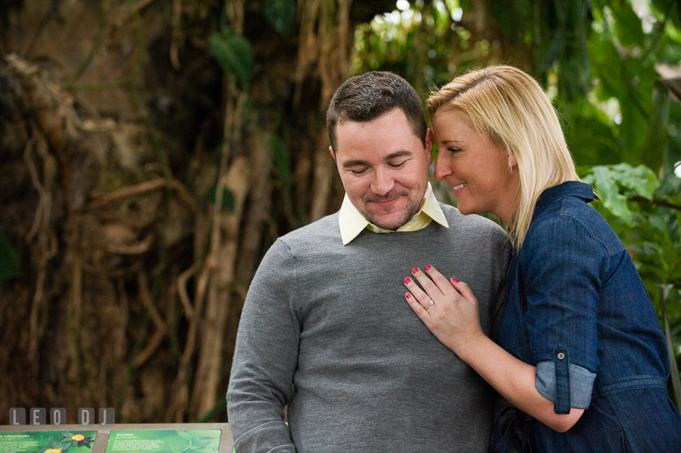 Engaged man embraced by his fiancée. Baltimore MD pre-wedding engagement photo session at National Aquarium in Baltimore, by wedding photographers of Leo Dj Photography. http://leodjphoto.com