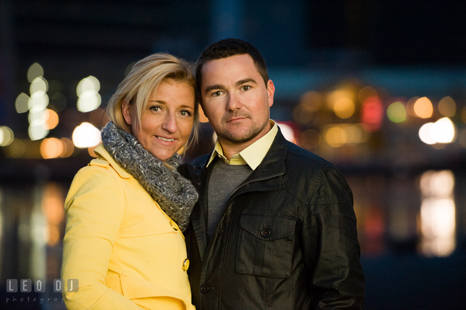 Engaged girl and her fiancé posing with the city light in the background. Baltimore MD pre-wedding engagement photo session at National Aquarium in Baltimore, by wedding photographers of Leo Dj Photography. http://leodjphoto.com