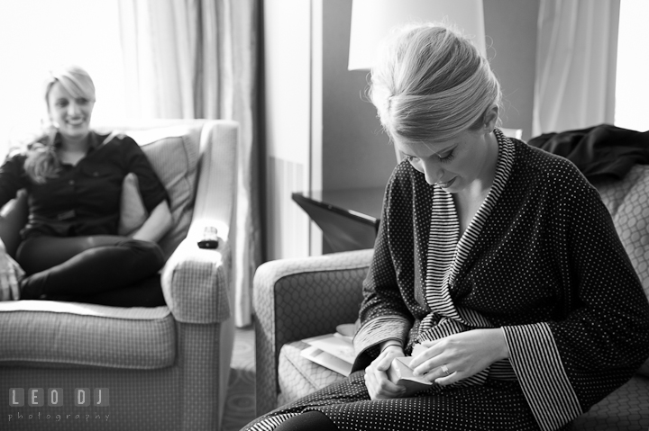 Bride opening gift from Groom. Getting ready wedding photos at Baltimore Marriott Waterfront by photographers of Leo Dj Photography. http://leodjphoto.com