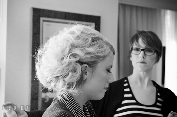 Make up artist spraying Bride's hair. Getting ready wedding photos at Baltimore Marriott Waterfront by photographers of Leo Dj Photography. http://leodjphoto.com