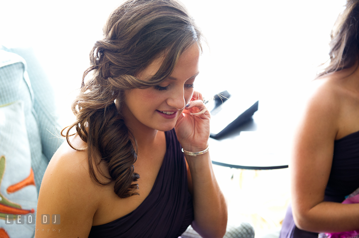 Bridesmaid wearing earrings. Getting ready wedding photos at Baltimore Marriott Waterfront by photographers of Leo Dj Photography. http://leodjphoto.com