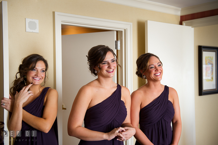 Bridesmaids looking at Bride wearing wedding dress. Getting ready wedding photos at Baltimore Marriott Waterfront by photographers of Leo Dj Photography. http://leodjphoto.com