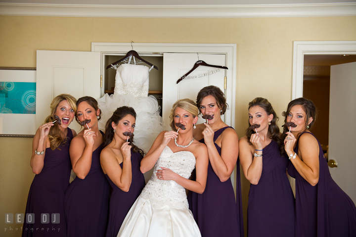 Bride, Matron of Honor, and Bridesmaids posing with chocolate mustache. Getting ready wedding photos at Baltimore Marriott Waterfront by photographers of Leo Dj Photography. http://leodjphoto.com