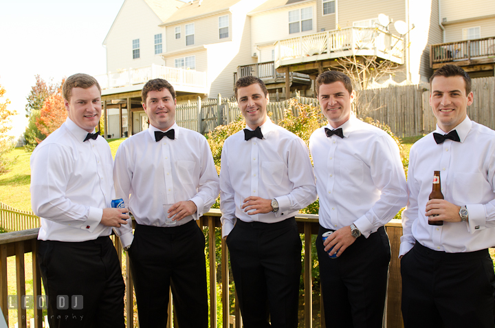 Groom, Best Man, and Groomsmen drinking outside on the terrace. Getting ready wedding photos at Baltimore Marriott Waterfront by photographers of Leo Dj Photography. http://leodjphoto.com