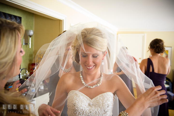 Mother of Bride put on veil on Bride. Getting ready wedding photos at Baltimore Marriott Waterfront by photographers of Leo Dj Photography. http://leodjphoto.com