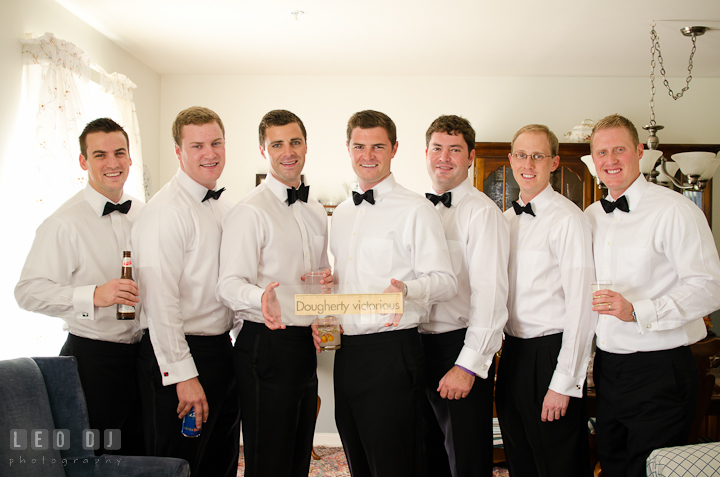 Groom, Best Man, and Groomsmen posing with sign. Getting ready wedding photos at Baltimore Marriott Waterfront by photographers of Leo Dj Photography. http://leodjphoto.com