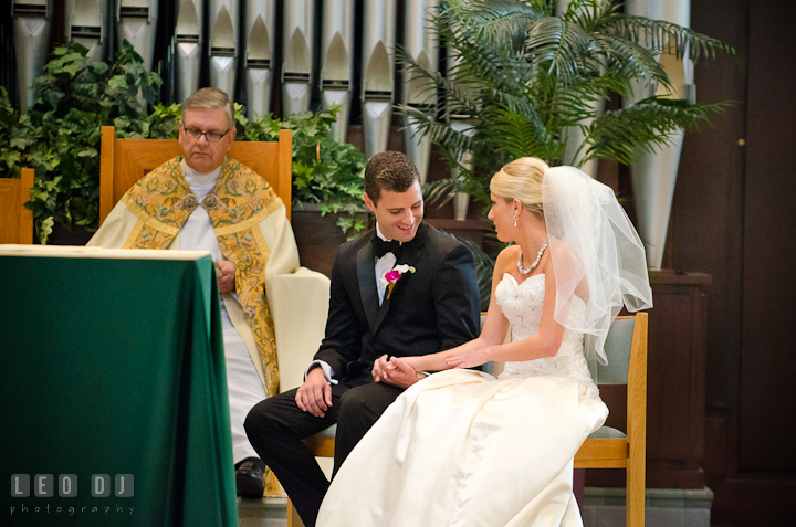 Groom and Bride smiling together during ceremony. Ceremony wedding photos at Sacred Heart Church, Glyndon, Maryland by photographers of Leo Dj Photography. http://leodjphoto.com