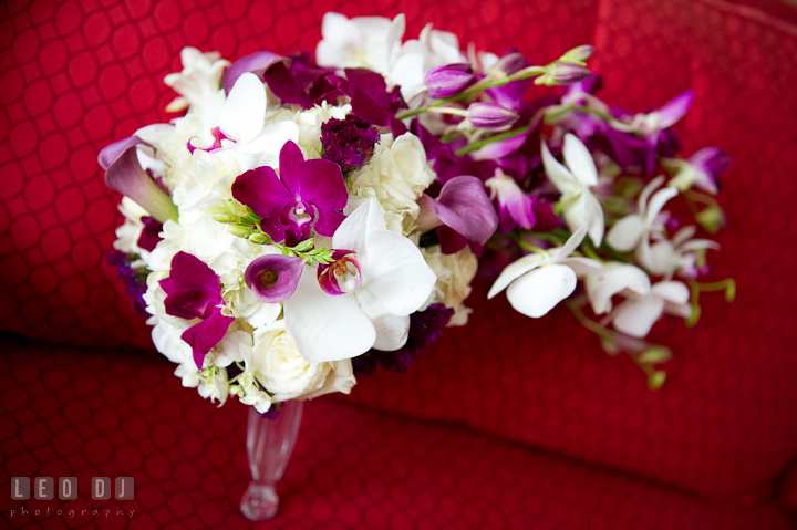 Bride's flower bouquet with cascading white and purple orchids designed by Bella Fiori Couture Floral and Events Design. Baltimore Museum of Industry wedding photos by photographers of Leo Dj Photography. http://leodjphoto.com