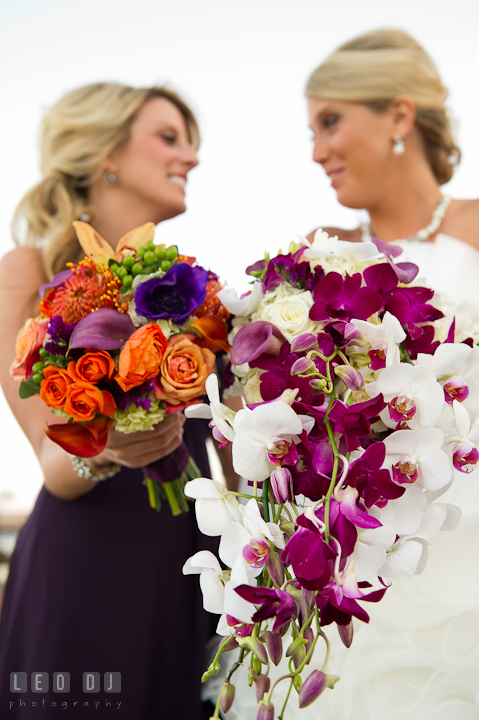 Bride and her Matron of Honor showing their beautiful flower bouquets. Baltimore Museum of Industry wedding photos by photographers of Leo Dj Photography. http://leodjphoto.com