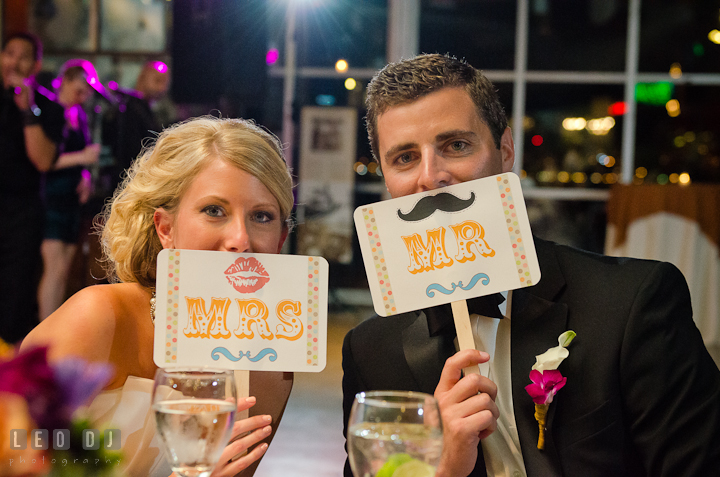 Bride and Groom holding Mr and Mrs signs. Baltimore Museum of Industry wedding photos by photographers of Leo Dj Photography. http://leodjphoto.com