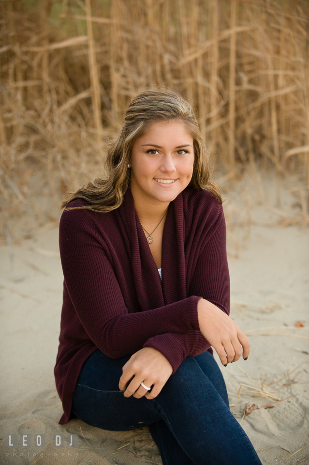 Beautiful girl sitting on beach sand. Eastern Shore, Maryland, Queen Anne's County High School senior portrait session by photographer Leo Dj Photography. http://leodjphoto.com