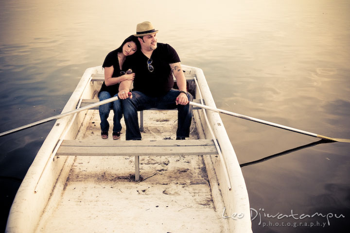 Engaged couple on a boat enjoying the peaceful water and the surrounding. Eastern Shore MD engagement pre-wedding photo session pier boat tattoo